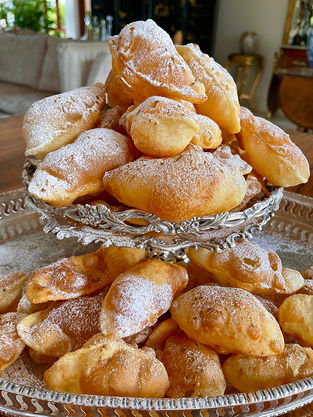 Silver cake stand with deep fried pastry puffs.
