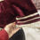 Thumbnail: women's maroon velvet V-neck blouse with gold trim and short sleeve