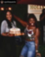 Two women celebrating with a birthday cheesecake at an event.