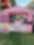 Woman at pink cheesecake stand for Our Story outdoor event
