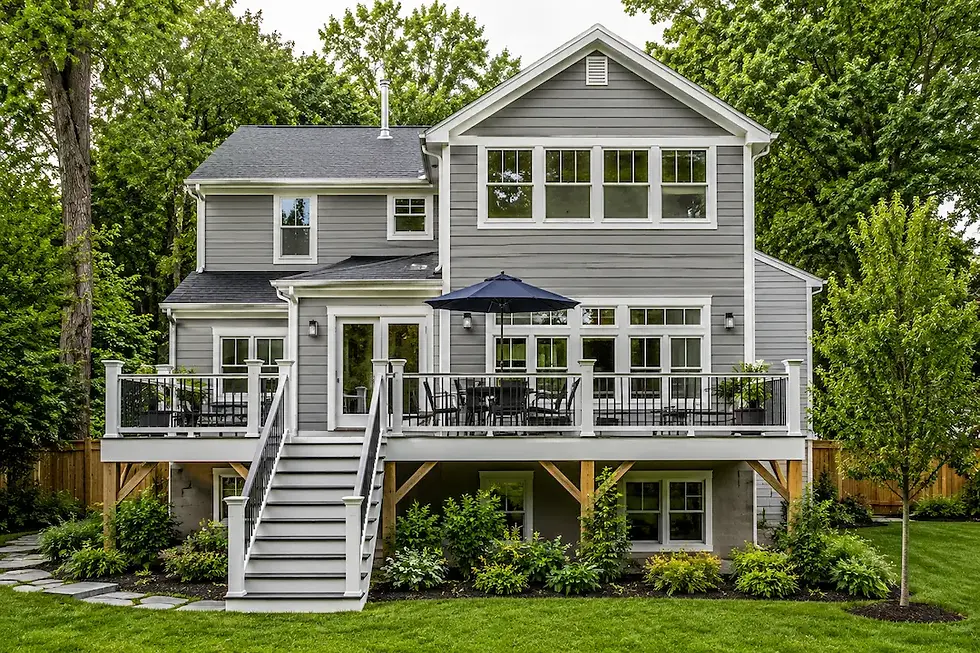 Completed two-level home addition with gray siding, elevated deck and white railed staircase in Arlington VA — Vale Construction