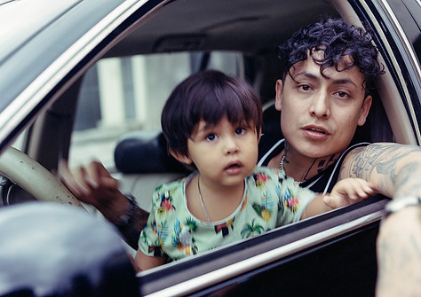 Aleman posing with his son and low rider at HOMEGROWN MAFIA HQ. shot on 120 film in Mexico