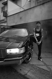 Aleman posing with his low rider at HOMEGROWN MAFIA HQ. shot on 120 film in Mexico City, M