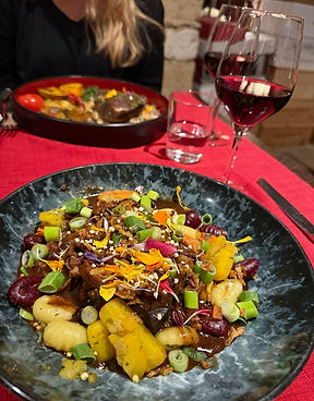 Boeuf bourguignon and a glass of red wine at Le Conty restaurant in Beaune, France