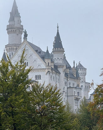 White Neuschwanstein Castle surrounded by greenery in Schwangau, Germany