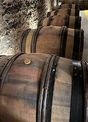 A line of brown wine barrels at Bouchard Aîné & Fils in Beaune, France