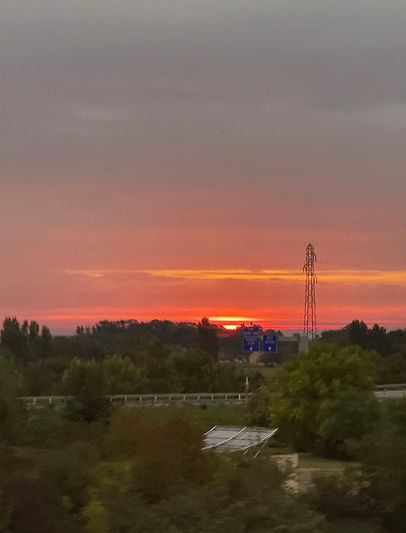Orange, pink and gold tones of a sunrise over Beaune, France