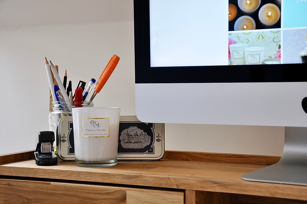 Office desk showing an un-lit scented candle