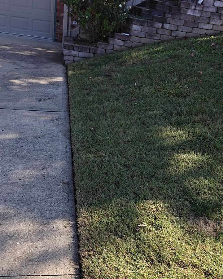 Sharp edge along a driveway walkway next to a freshly cut lawn