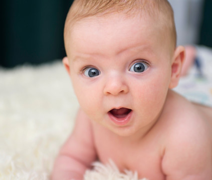 Young baby looking surprised