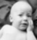 Black and white photo of a teary young baby