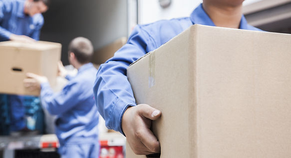 Experienced mover carrying a box, representing efficient and stress-free house removals.