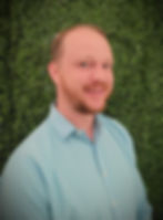Headshot of a staff member, possibly a chef or manager, smiling.