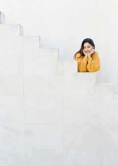 woman-leaning-white-steps-looking-away.jpg