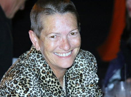 Photo of Maureen Shaw with her head shaved and a huge smile