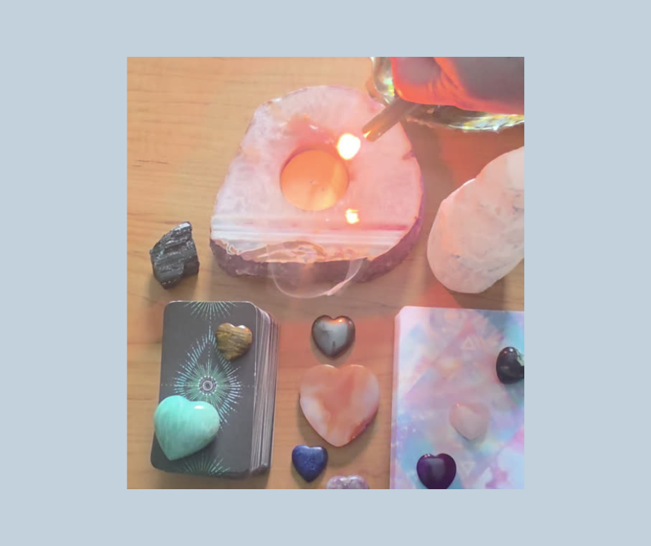 tarot and oracle cards with gemstones and an agate tea light candle holder