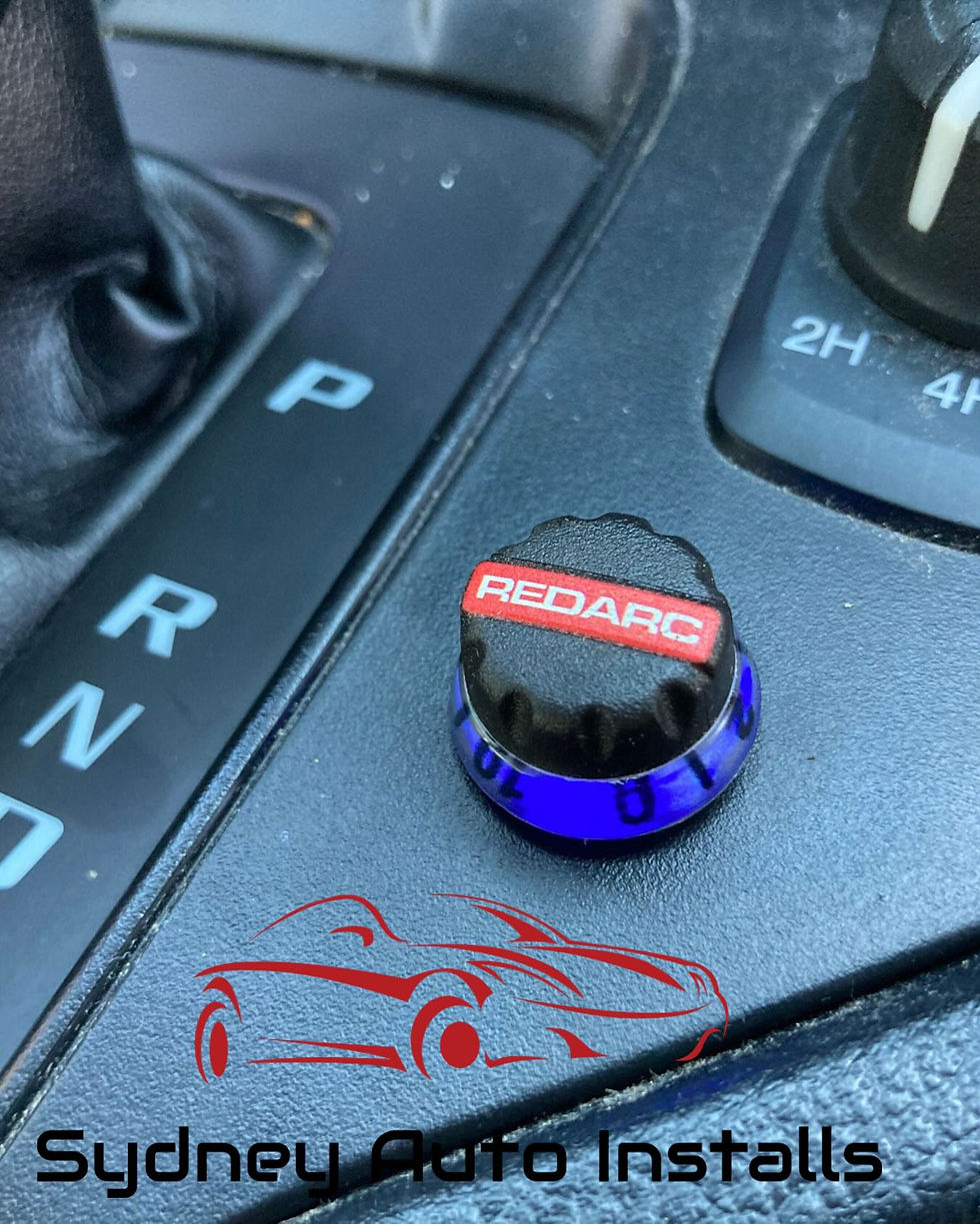 Eye-level view of a ute dashboard showing an electric brake controller installed