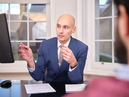 Dietitian consulting with client in clinical setting, reviewing health data and providing personalised nutrition and metabolic assessment for executive health optimisation.