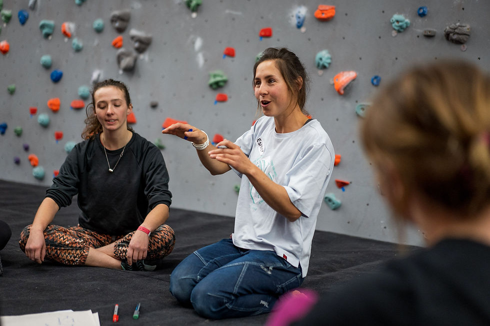 Climbing coach Esther Foster coaching a group of women at the Women's Climbing Symposium.