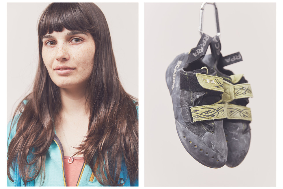 Portrait of a young woman climber with long hair and their Scarpa climbing shoes, taken at the Women's Climbing Symposium.