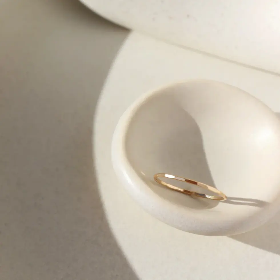 Thumbnail: A delicate 14k gold filled band made by hand, and lightly hammered to catch the light.