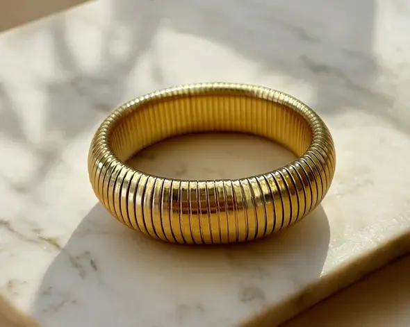 The Mykonos Bangle Bracelet, a bold and beautiful gold stunner, stack or wear solo.  18K gold plated.