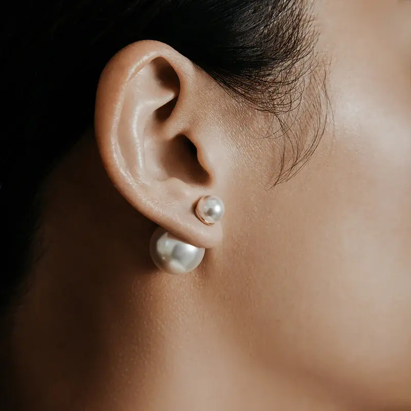 Thumbnail: Shashi's modern Double Ball Pearl Earrings.  Featuring a Swarovski Pearl.  Shown on model.