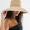 Thumbnail: Gigi Pip's Jolie packable straw bucket hat in natural.  Side view on model.
