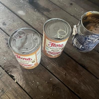 These cans were opened up by a raccoon