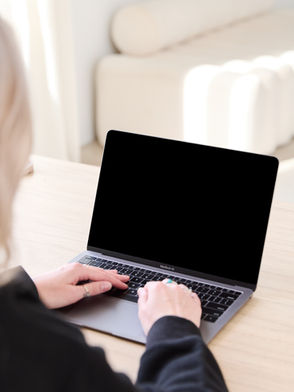 Website designer for therapists typing on laptop in Toronto Ontario Canada