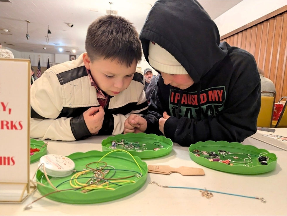 Kids choosing jewelry and keychain supplies at an Elf Workshop holiday event