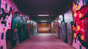 a tunnel with graffiti on the walls
