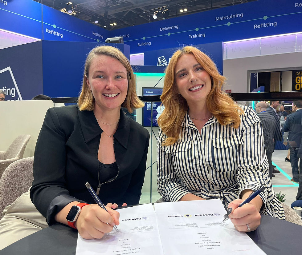 Sam Staincliffe (left side - Co-Founder & CEO of Uplift360) and Chloe Barker (right side - Managing Director for Babcock's UK Aviation) sign partnership contract at DSEI UK