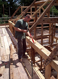 Tom Eggar working on the construction of a timber-frame building