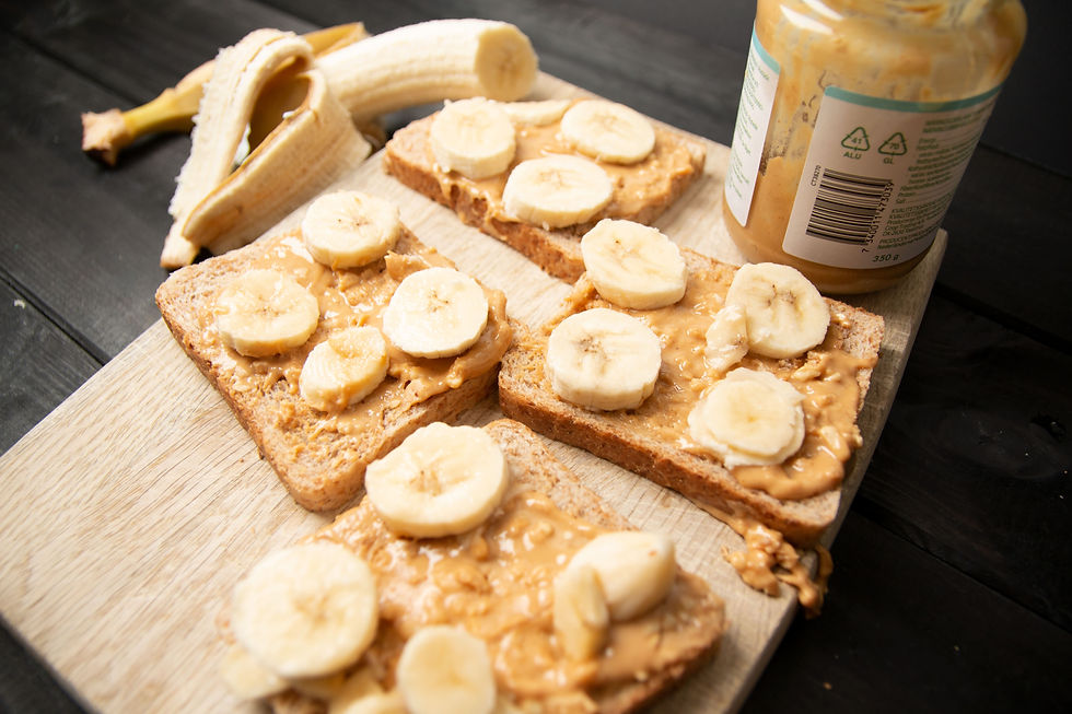 Peanut butter spread on toast bread, topped with banana slices.