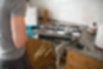 high-angle-view-man-repairing-gas-stove-home — велике.jpeg