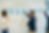 Two professionals collaborate in a bright modern meeting room, reviewing a hand drawn customer journey map on a whiteboard with stages from Closed Won to Advocacy, using blue sticky notes to plan long term customer success beyond the initial sale.
