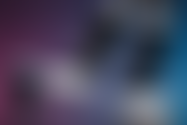 A small humanoid robot standing beside the large mechanical legs of a much bigger robot, highlighting the scale difference between two AI machines.