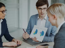 Sales team reviewing input metrics and performance data during a prospecting strategy meeting, focusing on activity tracking and results analysis.