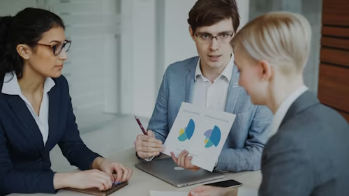 Sales team reviewing input metrics and performance data during a prospecting strategy meeting, focusing on activity tracking and results analysis.