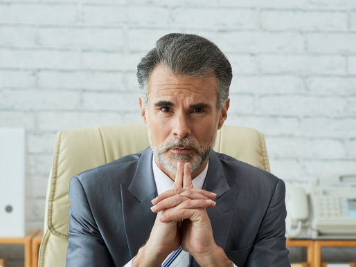 Entrepreneur working on a laptop at a desk, focused on business planning and sales strategy.