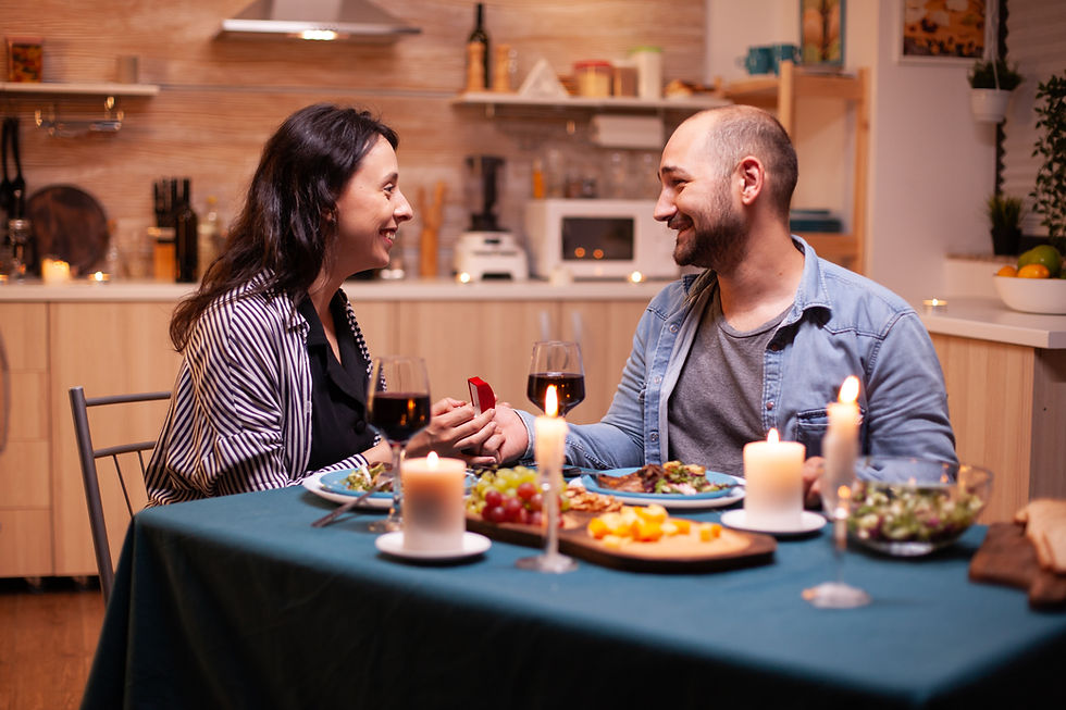 Couple enjoying a candlelit dinner at home while sharing a happy moment, illustrating how meaningful everyday experiences can strengthen relationships and counter hedonic adaptation.