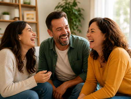 People laughing together in a warm, natural setting showing the mental and physical health benefits of laughter