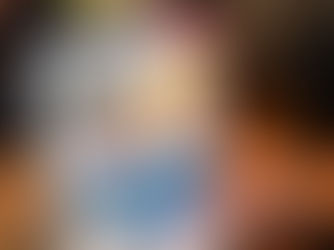 A person browsing an ecommerce website design on a laptop, featuring a fashion store with discounted clothing items and a "SALE" banner, in a cozy café setting.