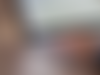 Close-up of a person typing on a laptop keyboard, with lines of computer code visible on the screen, suggesting software development or programming work.