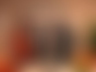 Sales and marketing professionals collaborating in a conference room, reviewing documents and strategy on a laptop and whiteboard to align on shared revenue goals.