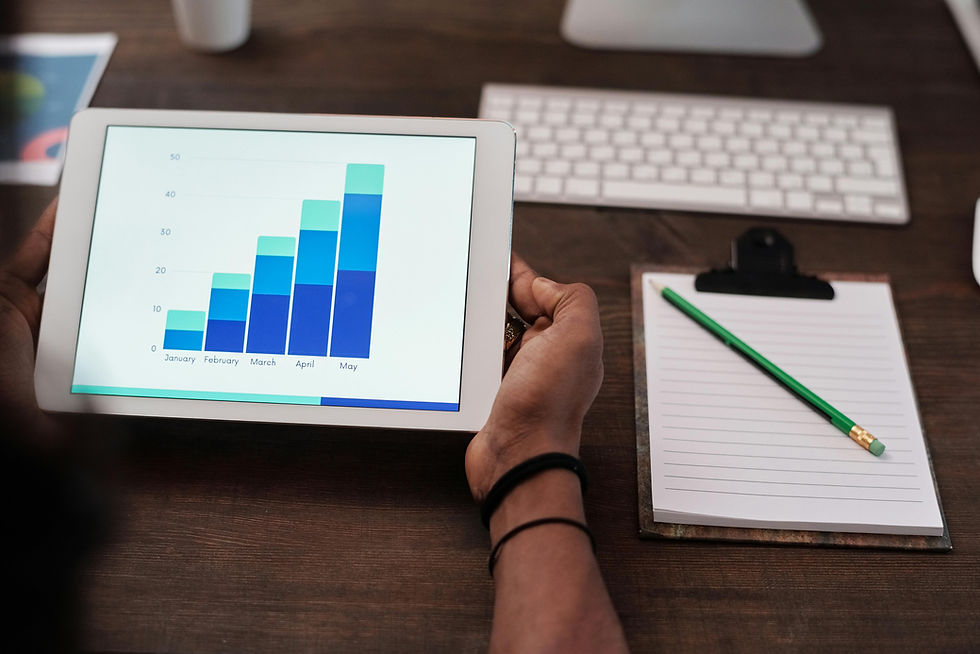 Person analyzing predictive analytics data on a tablet with a growth chart