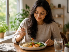 A person eating a healthy meal slowly at a clean table with full attention, demonstrating mindful eating without distractions in a calm and natural setting.