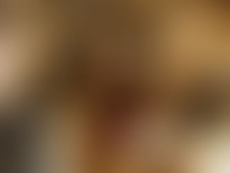 A young woman wearing a brown coat and striped scarf speaks to a salesperson across a wooden counter in a warmly lit store. A small sign on the counter reads “Extra 40% Off – Final Sales Styles,” and wrapped gift boxes sit nearby. Shelves and home décor items are visible in the background.