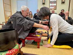 Sensei adjusts Kyosei’s Rakusu